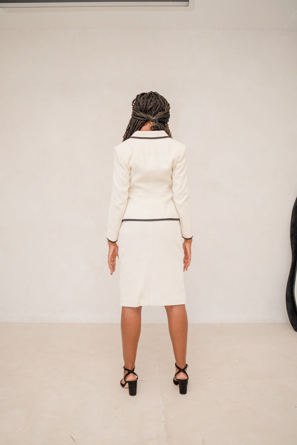 The beige piped peplum tweed skirt suit